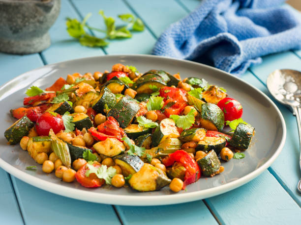 Chickpeas with vegetables over baking paper