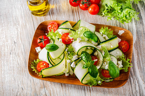 Salad with salty, boiled zucchini and flower cheese